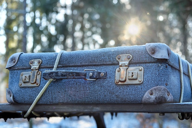 blue suitcase on the roof rack of a car