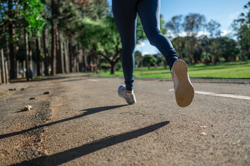 Women's feet in sneakers - walking outside
